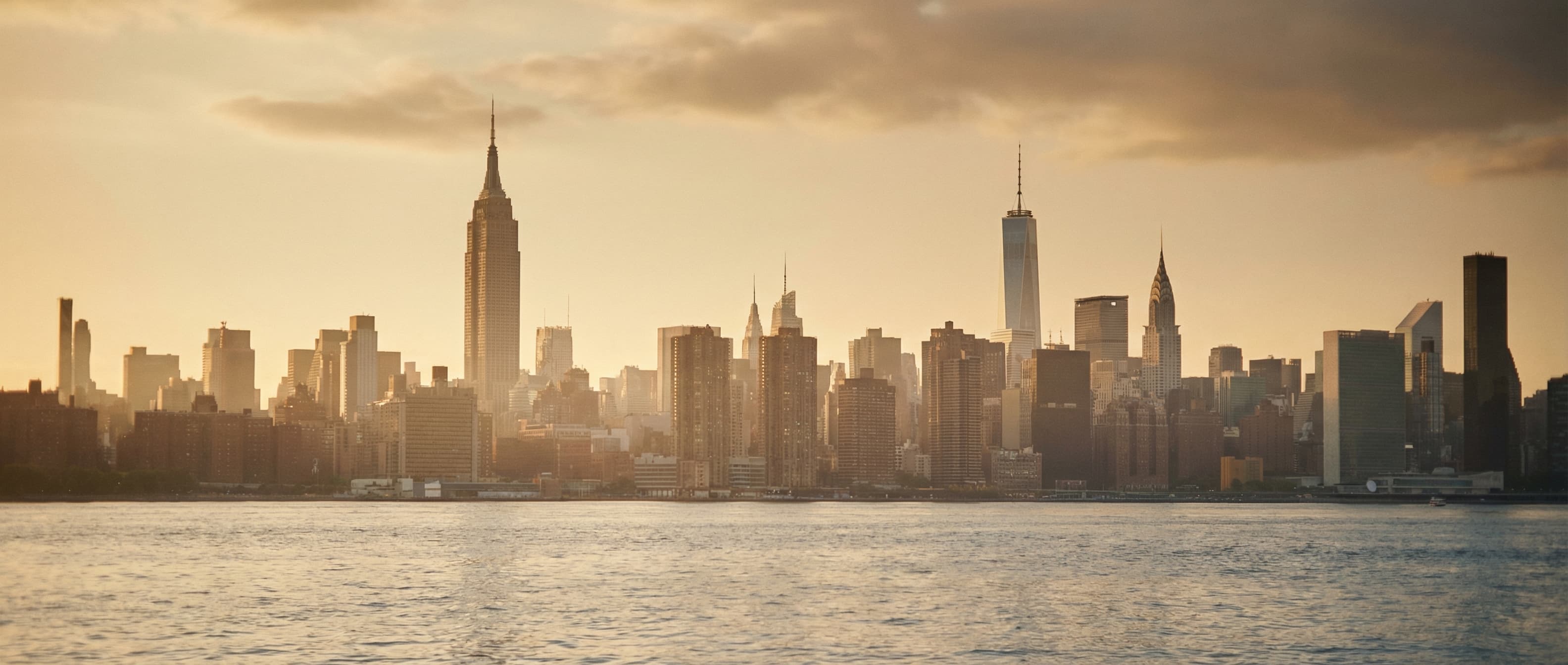 NYC skyline with apartment buildings - The Complete NYC Apartment Hunting Guide for 2026 covering FARE Act, rent stabilization, and neighborhood comparisons